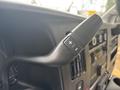 Close-up of the gear shift lever of a 2020 Chevrolet Express with a plus and minus control button
