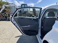 A white 2015 Hyundai Sonata with the driver's door open, showcasing the interior design and seating arrangement