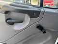 Interior door panel of a 2014 Freightliner M2 106 featuring a door handle and window crank knob