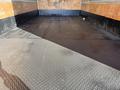 A 2014 Hino 195 truck with an empty cargo area featuring a smooth metal floor and wooden walls