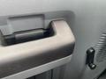 A close-up of the handle of a 2014 Ford F-350 SD interior door with a textured surface and a matte finish