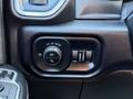 Close-up view of the control panel in a 2023 RAM 3500 featuring light settings including auto headlights and fog lights