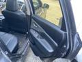 A 2017 Nissan Murano with an open door revealing a black interior and seats