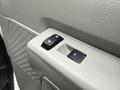Close-up view of the control panel on a 2024 Ford E-450 door featuring power window switches and a textured surface