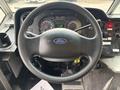 Steering wheel of a 2012 Ford E-450 Super Duty with dashboard instruments and controls visible