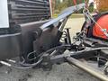 A close-up of the hitch mechanism and hydraulic components on a 2013 Freightliner 114SD truck