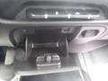 Control panel and storage compartment of a 2015 Chevrolet Silverado 1500 interior with knobs and a small open space for items