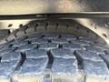 Close-up of a treaded tire on a 2013 International 7500 showing deep grooves and a robust construction designed for heavy-duty performance