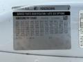 A 2017 Chevrolet Express with a service parts identification label displaying various codes and specifications