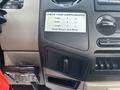 A 2009 Ford F-450 Super Duty dashboard with controls and a printed checklist for checking surroundings measurements