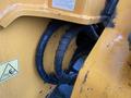 Close-up of two black rubber hoses connected to a yellow machinery component possibly from a 2016 Hyundai HL940