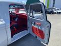 A 1962 Ford 2WHDR with an open door showing a red interior and dashboard layout