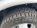 Close-up of a rugged tire on a 2020 Chevrolet Express showing detailed tread pattern and shiny rim