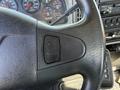 Close-up of the steering wheel and dashboard controls of a 2008 International 7500 showing various dials and gauges