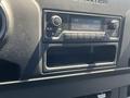 A dashboard display of a 2022 Mercedes-Benz Sprinter featuring radio controls and a digital clock