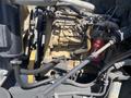 A close-up view of the engine of a 1996 GMC Top Kick showing various parts including hoses and a red component