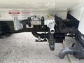 A 2006 Freightliner M2 106 featuring various plumbing connections including hoses and valves integrated into the chassis structure