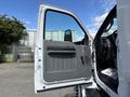 The image shows the open driver's side door of a 2016 Ford F-750 with a gray interior panel and a view of the dashboard inside the truck