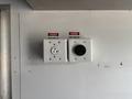 Two electrical outlets labeled 220 volts with a warning sign indicating danger
