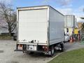 A white 2014 Hino 195 box truck with a blank rear cargo area and visible bumper details parked in a lot