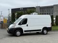 A white 2020 RAM Promaster van with a high roof and a refrigeration unit mounted on top parked in a lot