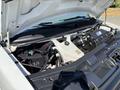 The image shows the engine compartment of a 2019 GMC Savana with the hood raised displaying the engine components and cooling system
