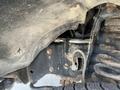 Close-up view of the undercarriage of a 2014 Ford F-250 SD showing suspension components and axle details