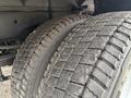 Close-up of the rugged tires of a 2023 Ford F-450 Super Duty showcasing deep treads and a sturdy design for improved traction and durability