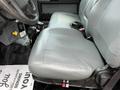 A gray seat from a 2017 Ford F-750 positioned in the driver's area with seat controls and a floor mat partially visible