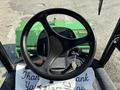 View of the steering wheel and control panel of a 2021 John Deere 1575 tractor