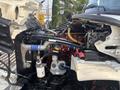 2010 Freightliner M2 106 with open hood exposing the engine components including hoses filters and wiring
