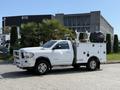A white 2020 Ram 2500 pickup truck with a service bed features tool compartments and equipment on top
