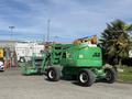 A 2015 JLG 450AJ aerial work platform in green with large tires and an extended boom attached for reaching elevated areas
