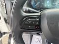 Close-up of the steering wheel controls of a 2023 RAM Promaster 3500 showing buttons for phone and navigation functions