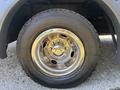 Close-up of a shiny chrome alloy wheel and tire of a 2020 Chevrolet Express with a Goodyear tire mounted on it