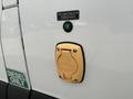 A close-up of the fuel access point on a 2020 Mercedes-Benz Sprinter 2500 featuring a gold connector labeled for electric supply with a green indicator light nearby