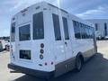 A white 2020 Chevrolet Express bus with a wheelchair access door and multiple rear lights
