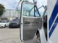 A 1994 GMC Vandura 3500 van with the driver's door open showcasing the interior details and door panel design