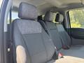 Interior view showcasing the gray fabric seats of a 2023 Ford F-350 SD with two front seats and a rear bench seat visible