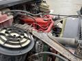 A 2019 Freightliner M2 engine showing various components including a red engine cover an air filter and multiple hoses and wiring connections