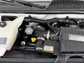 The image shows the engine compartment of a 2013 Chevrolet Express featuring various components such as hoses a coolant reservoir and an air intake assembly