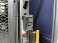 A control panel with buttons labeled up down fold and unfold mounted on a metal surface inside a vehicle
