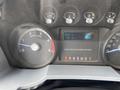 Dashboard of a 2015 Ford F-550 showing gauges for RPM and fuel levels along with a digital screen displaying trip information and fuel type