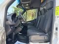 Interior of a 2019 Mercedes-Benz Sprinter featuring a driver seat and passenger seats in a gray fabric finish with a simple dashboard design