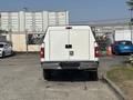 A 2019 Ford F-150 with a white cargo bed is parked facing away, featuring a double rear door design and tall taillights