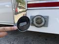 A person pointing at the rear power outlet of a 2019 Ford Econoline van