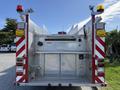 Rear view of a 1992 Emergency One Typhoon Superior fire truck featuring red and white reflective stripes multiple emergency lights and a metallic body