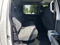 Interior of a 2021 Ford F-150 showing the rear seating area with gray fabric seats and a spacious layout