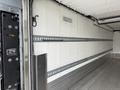 Interior of a 2019 Ford F-750 truck with a metal side wall and rail system for securing cargo
