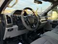 Interior of a 2018 Ford F-350 SD featuring a steering wheel dashboard and seats in a light gray fabric